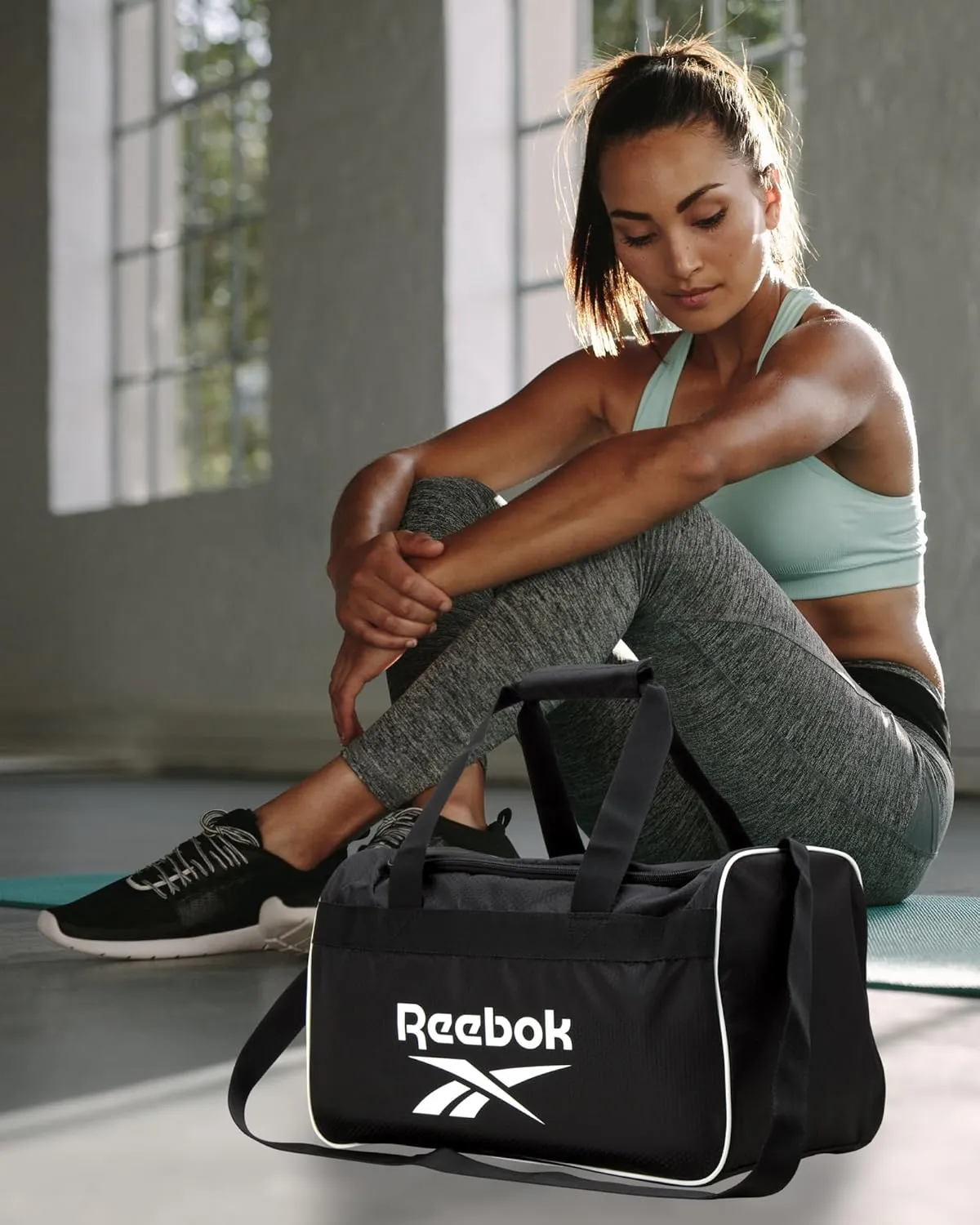 Reebok Duffle Bag – Gym Bag for Women & Men, Carry On and Overnight Duffle for Travel & Fitness, Size Small, Warrior II Black with Contrast Logo